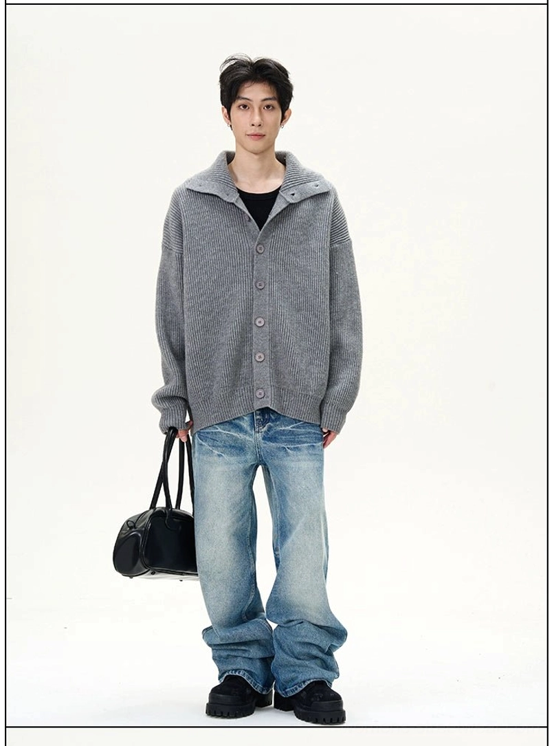 Male model styling faded blue wash wide-leg jeans with a gray cardigan for a modern relaxed streetwear look