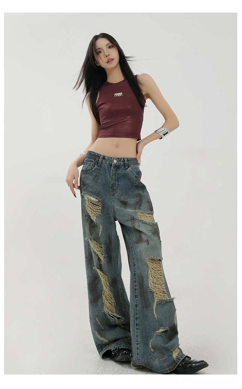 Blue washed distressed wide-leg denim jeans with relaxed draped fit and vintage Y2K streetwear styling