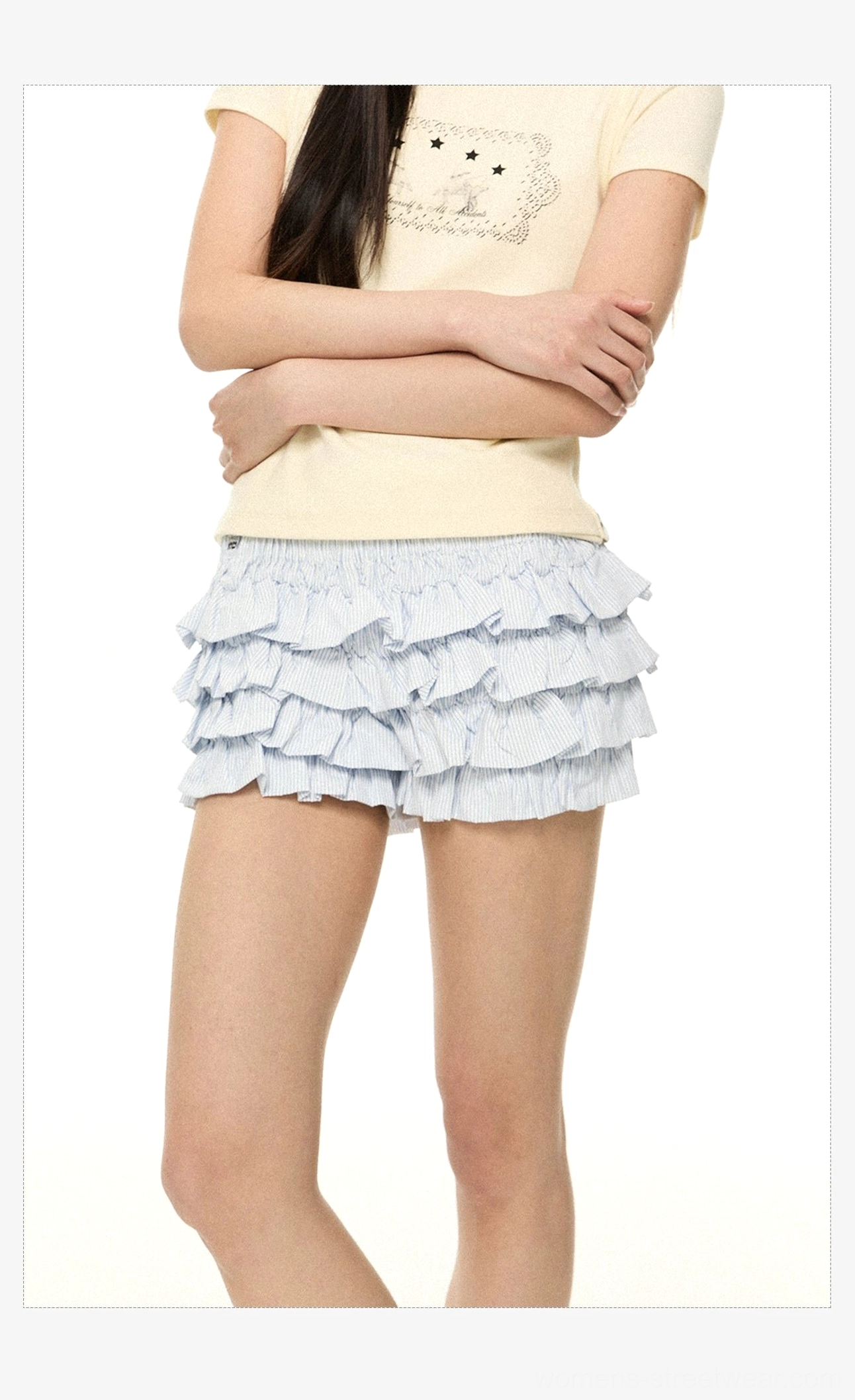 Blue and white pinstripe ruffle mini shorts shown in a cropped front side view with a yellow cropped tee and layered hem
