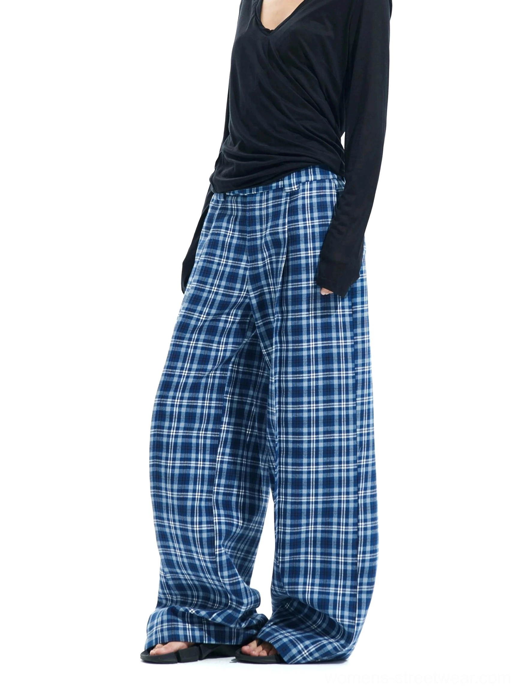 Side view of blue and white plaid wide-leg cotton pants with elastic waistband, relaxed full-length silhouette and black long-sleeve top