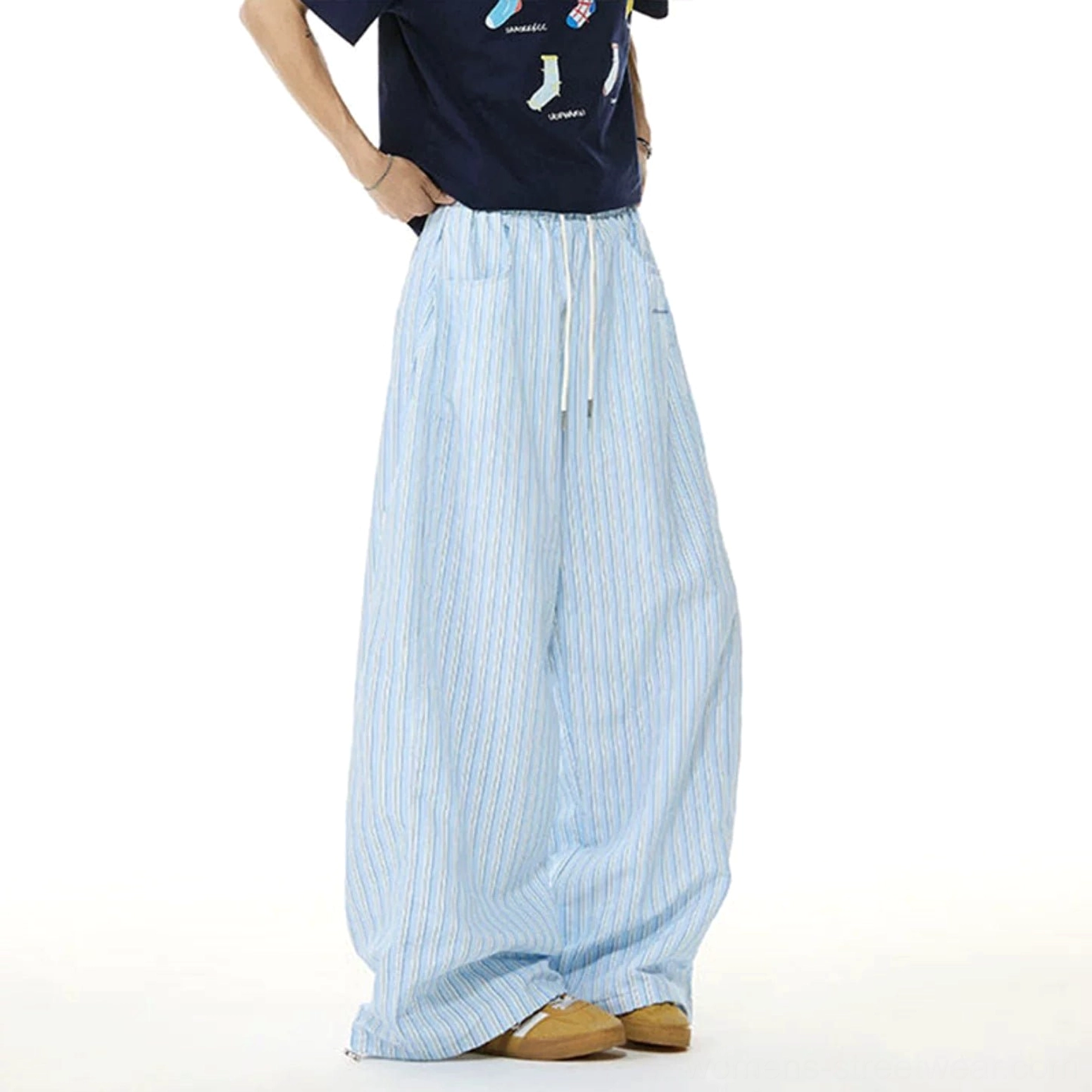 Rear angled view of light blue and white striped women's wide-leg streetwear lounge trousers with relaxed drape and elastic drawstring waist