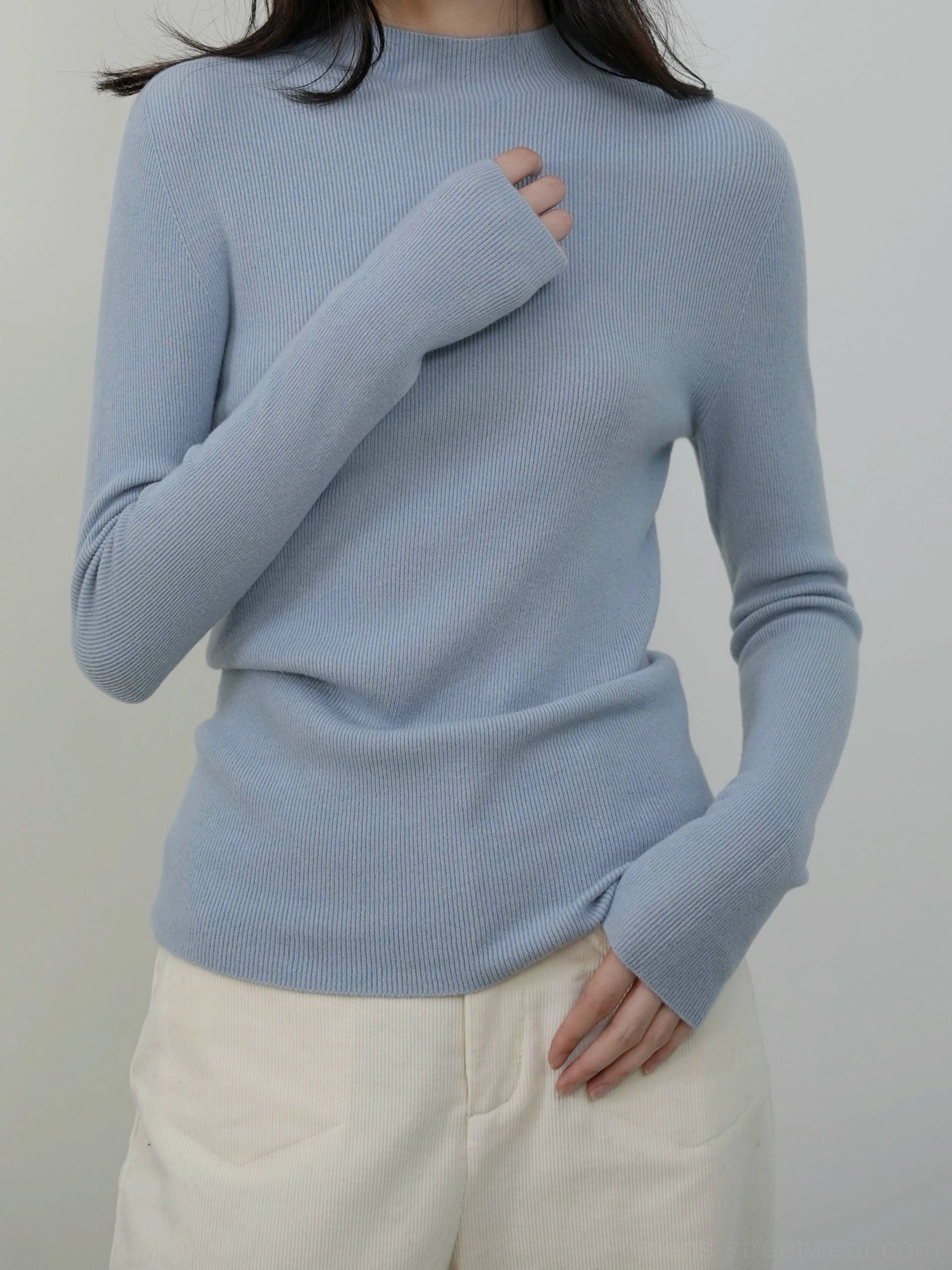 Blue women's mock neck knit sweater with long sleeves and a slim ribbed silhouette for casual streetwear