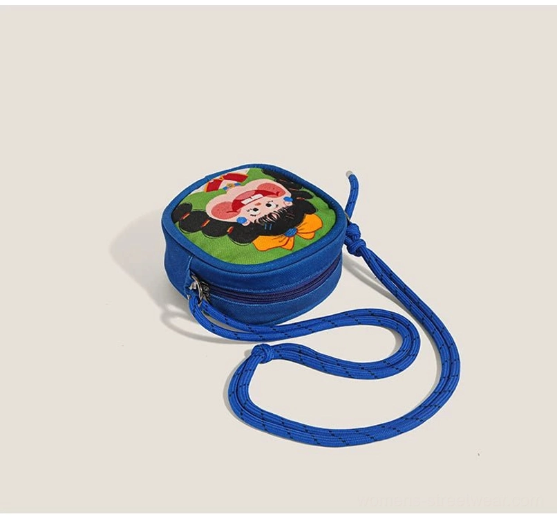 Blue Y2K mini shoulder bag with orange bow cartoon character print and secure zippered edge