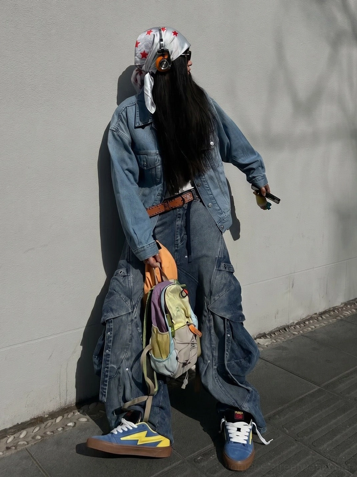 Full body streetwear outfit featuring blue yellow lightning bolt skate sneakers with a denim set and backpack