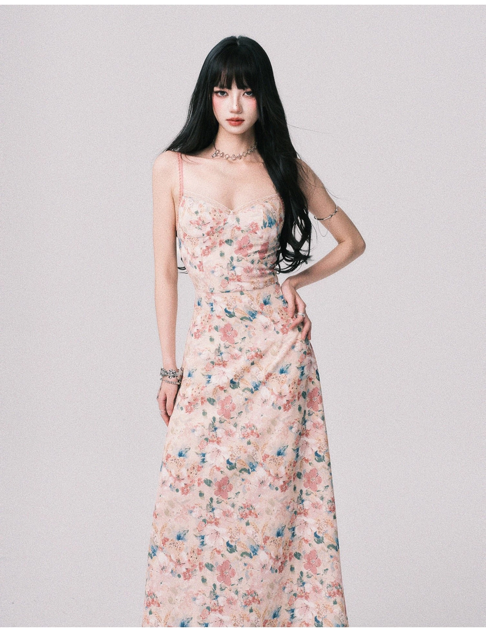 Three quarter view of a blush garden floral maxi dress with ruched bust, high fitted waist, flowing skirt, and soft watercolor flower print