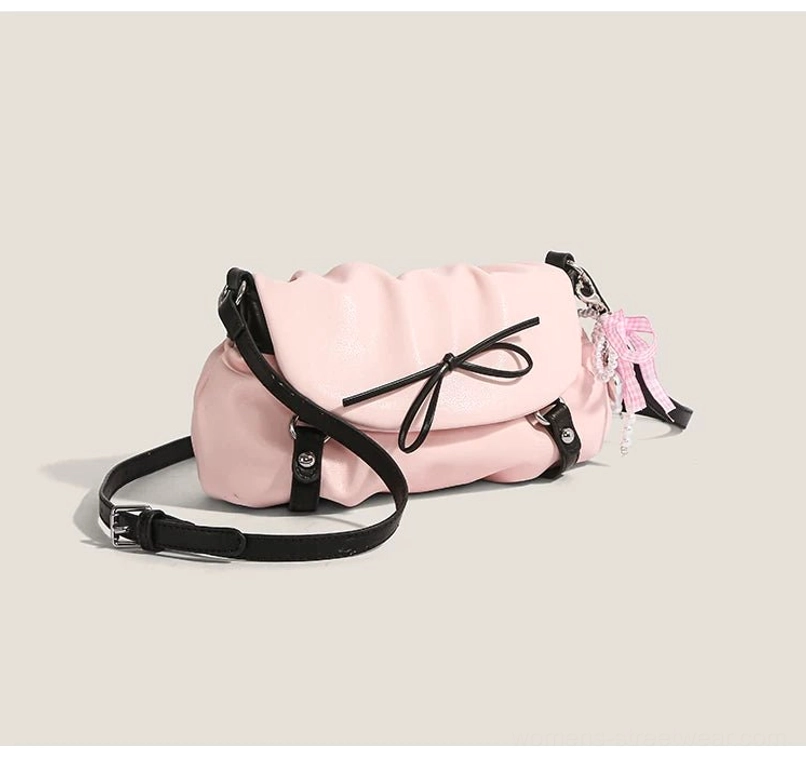 Pink ruched bow shoulder satchel side profile with black hardware contrast straps and gingham lace ribbon charm