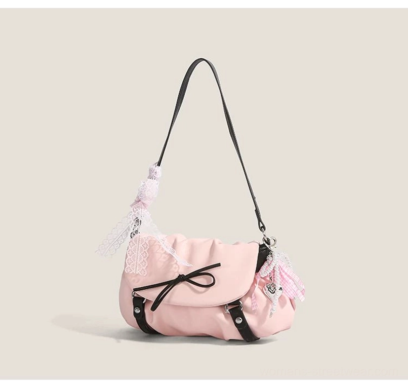 Pink ruched Y2K flap shoulder bag side three quarter view with black strap gingham ribbon charm and front bow