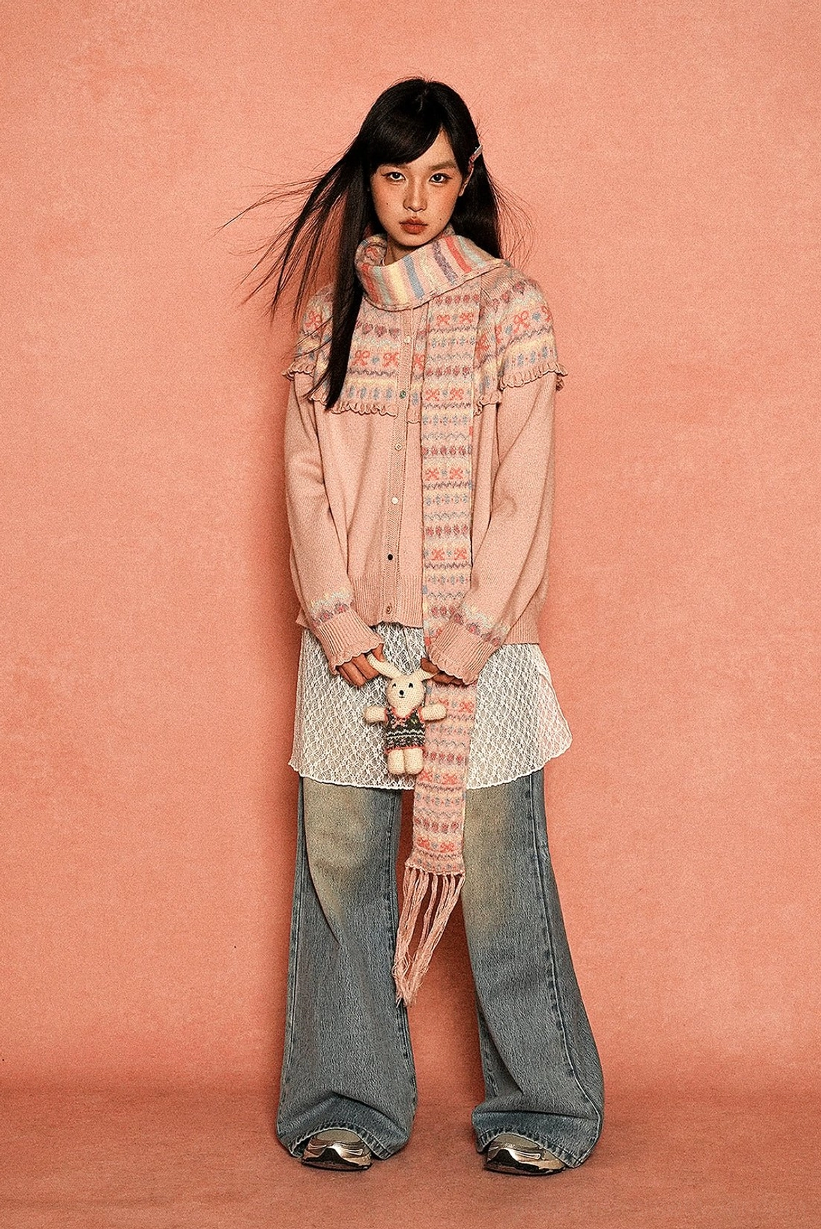 Blush pink Fair Isle fringe cardigan with relaxed fit and matching patterned tassel scarf styled with wide-leg denim