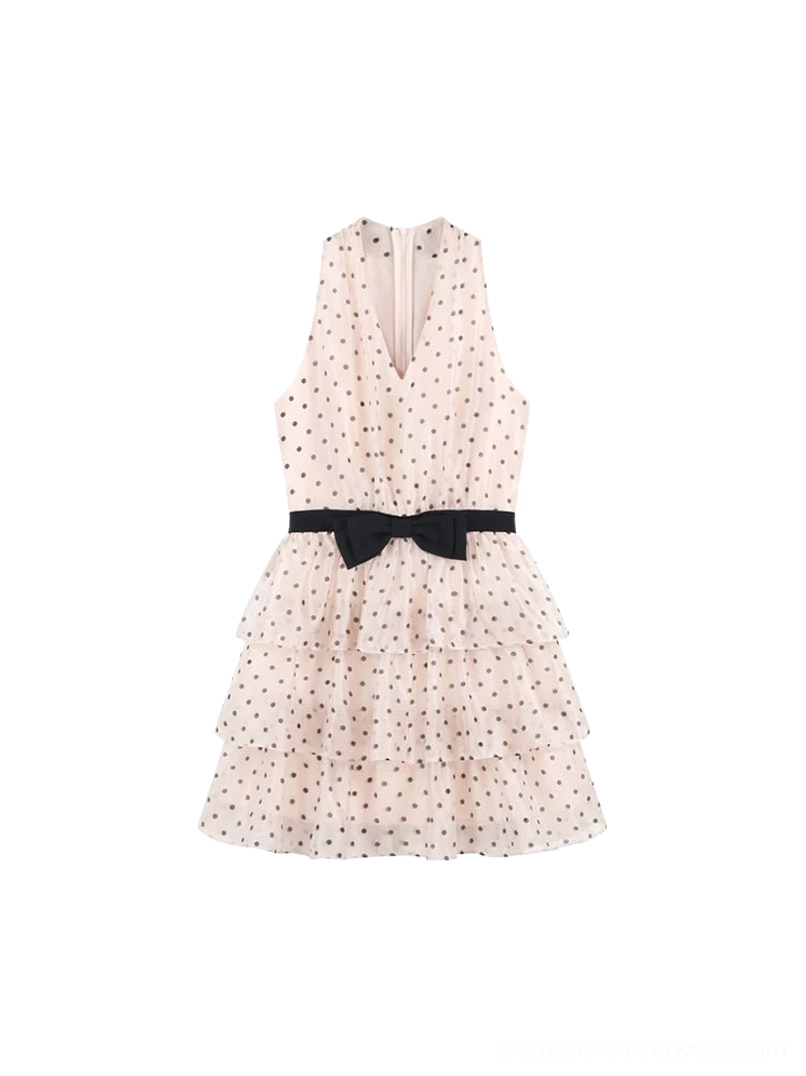 Blush pink polka dot bow halter tiered mini dress flat lay showing V-neckline and layered ruffle skirt
