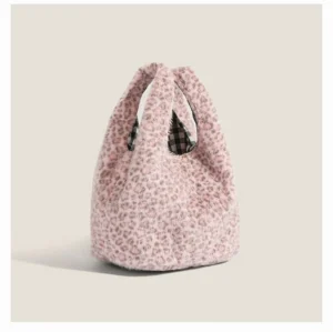 Blush pink snow leopard plush mini hobo tote bag front three quarter view with black and white gingham lining