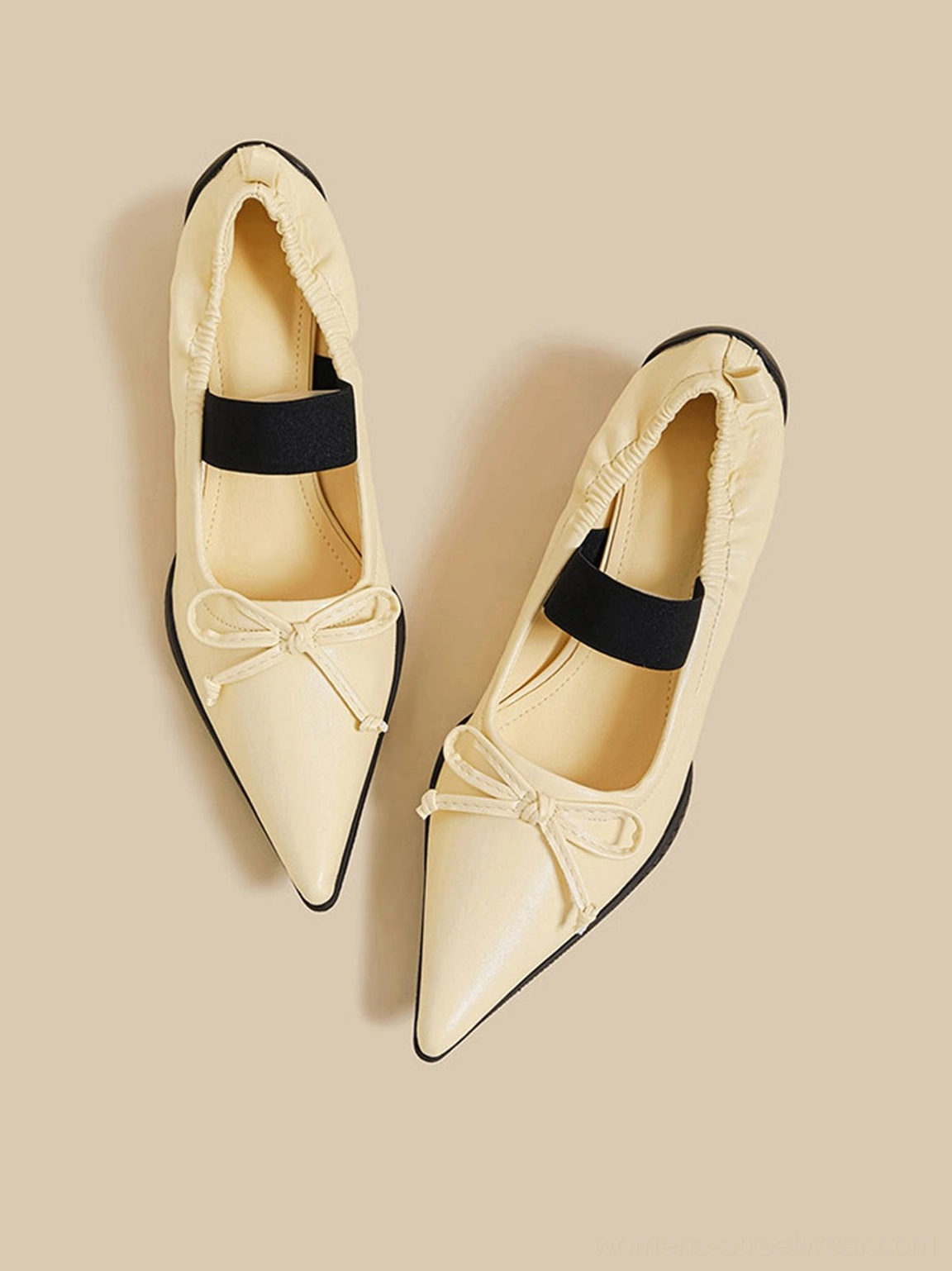 Bow pointed-toe Mary Jane mule heels showcasing the elegant curved topline and sculptural silhouette