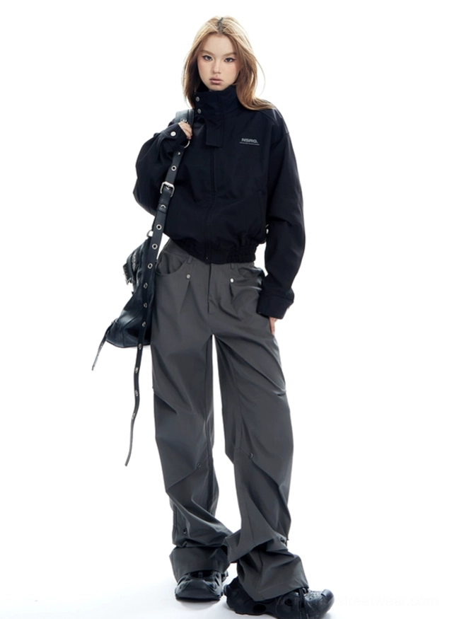 Cropped bomber jacket fashion look highlighting the boxy silhouette, gathered hem, high collar, and relaxed sleeve volume