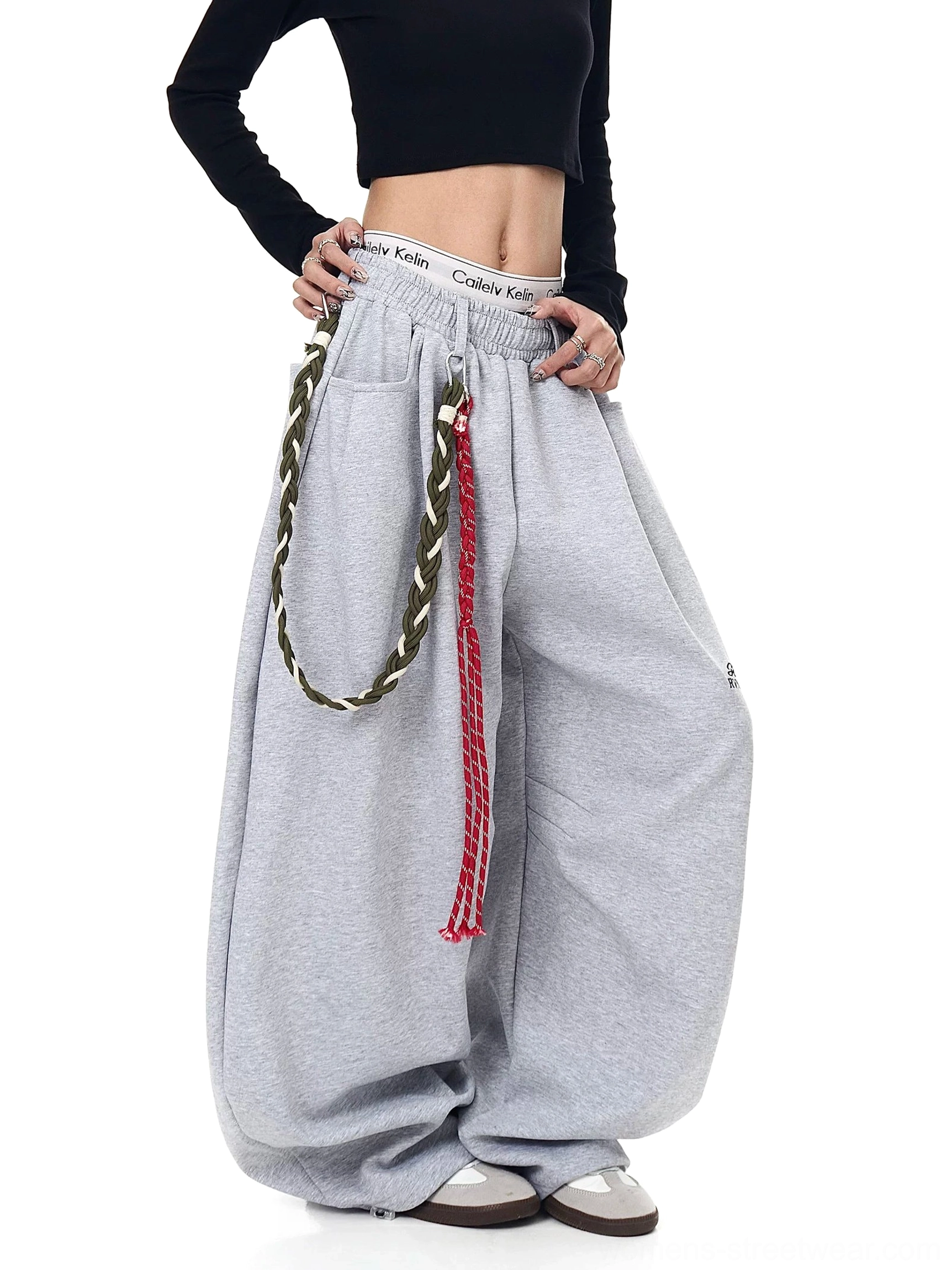 Heather gray ultra-wide fleece streetwear pants with contrast braided rope detail three-quarter side view