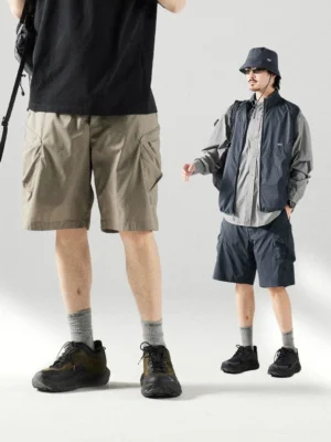 Outdoor cargo shorts in khaki and navy blue styled on male models with relaxed streetwear silhouettes