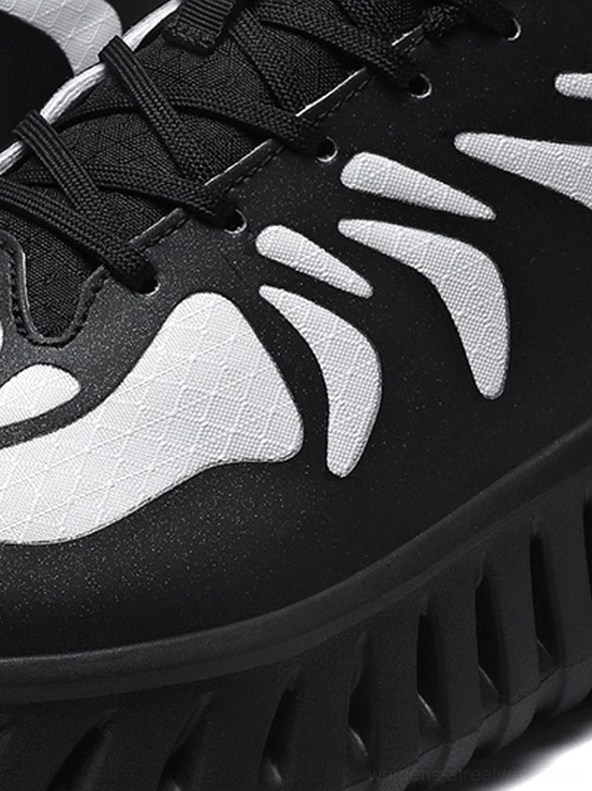 Streetwear running sneakers with breathable paneled construction, contrast colorblocking, bold skeletal-style detailing, and rugged urban sole