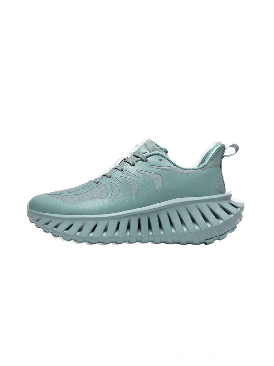 Green colorblock running sneakers with breathable paneled upper, lace-up fastening, rugged serrated outsole, and contemporary outdoor streetwear styling