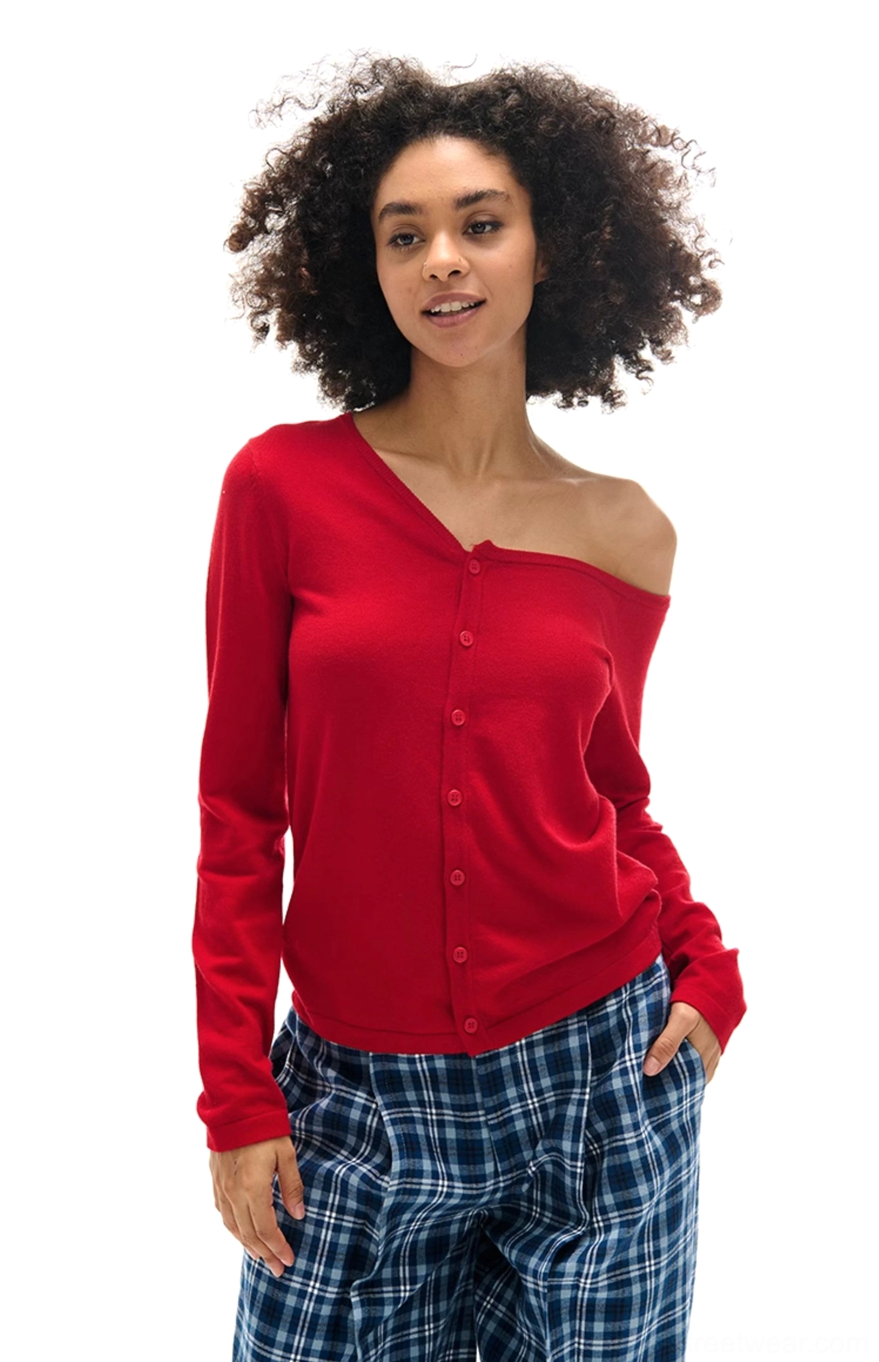 Bright red asymmetrical button-front knit cardigan with an exposed shoulder and wide-leg plaid trousers