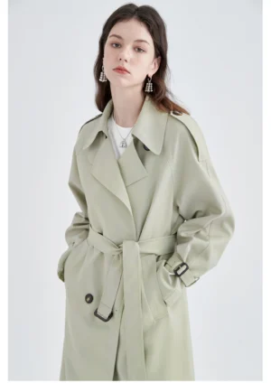 Relaxed British trench coat half-body shot sage green double-breasted closure notched lapel minimalist aesthetic
