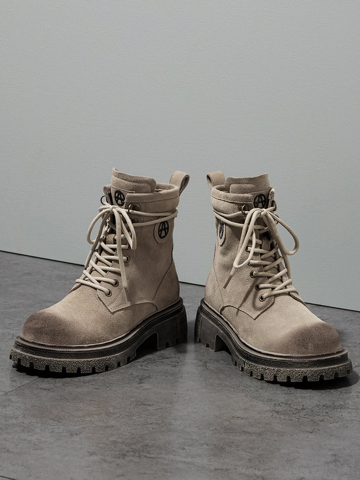Brown distressed combat boots and gray distressed combat boots side-by-side comparison showing color variations weathering