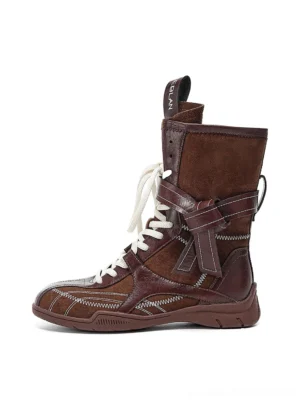 Brown asymmetric foldover lace-up mid-calf utility boots with mixed split leather panels contrast stitching and ankle buckle strap shown in side view