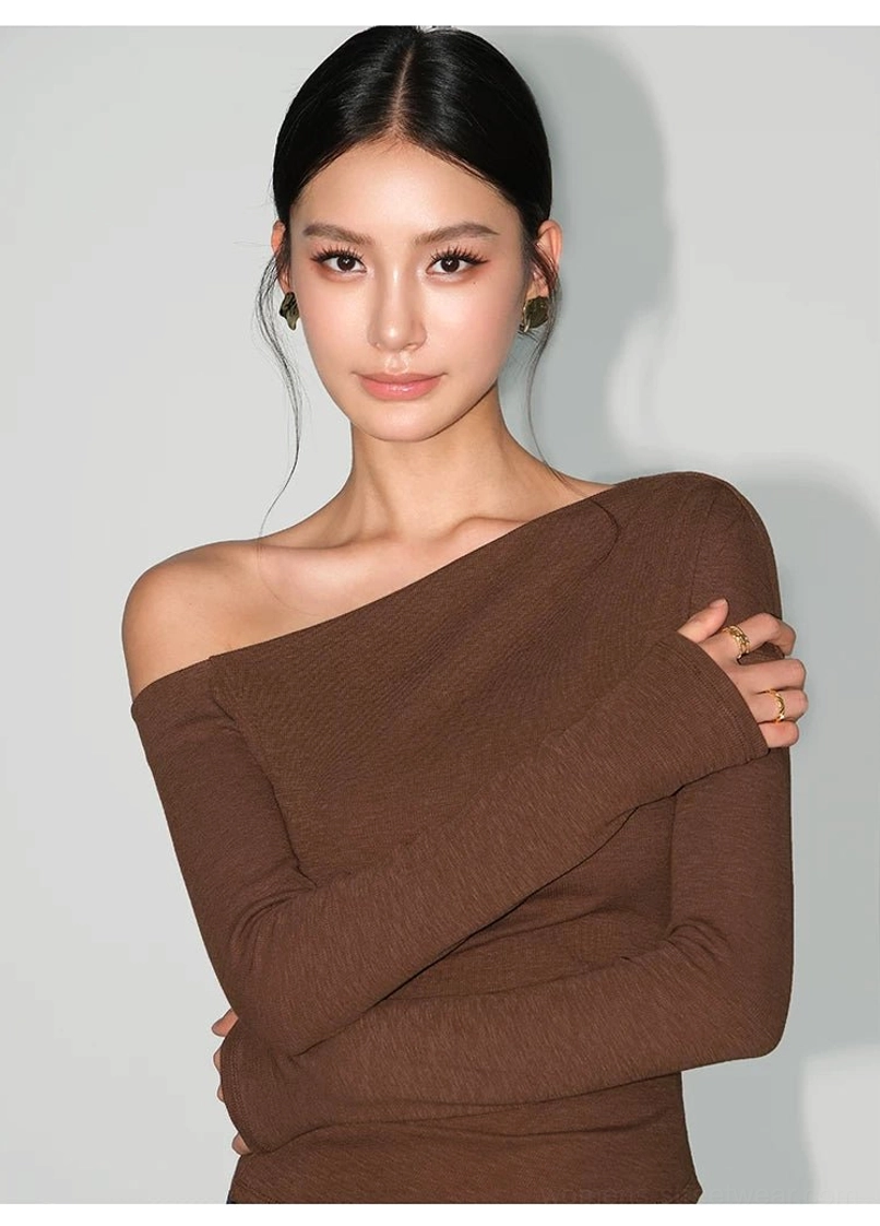 Brown fitted asymmetric one-shoulder long-sleeve tee showing the exposed shoulder and full-length sleeves