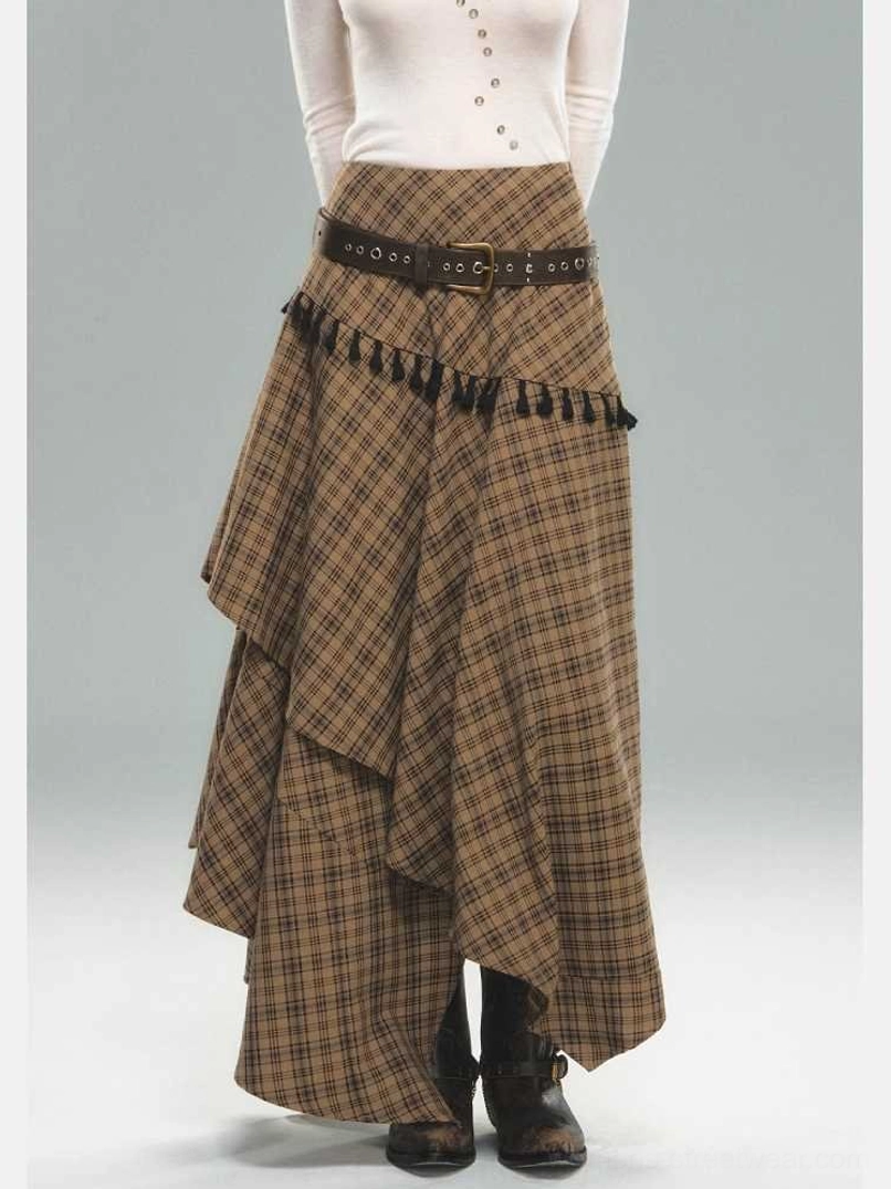 Front close-up of brown asymmetric plaid skirt with black tassel waist trim, draped hem, and statement belt styling