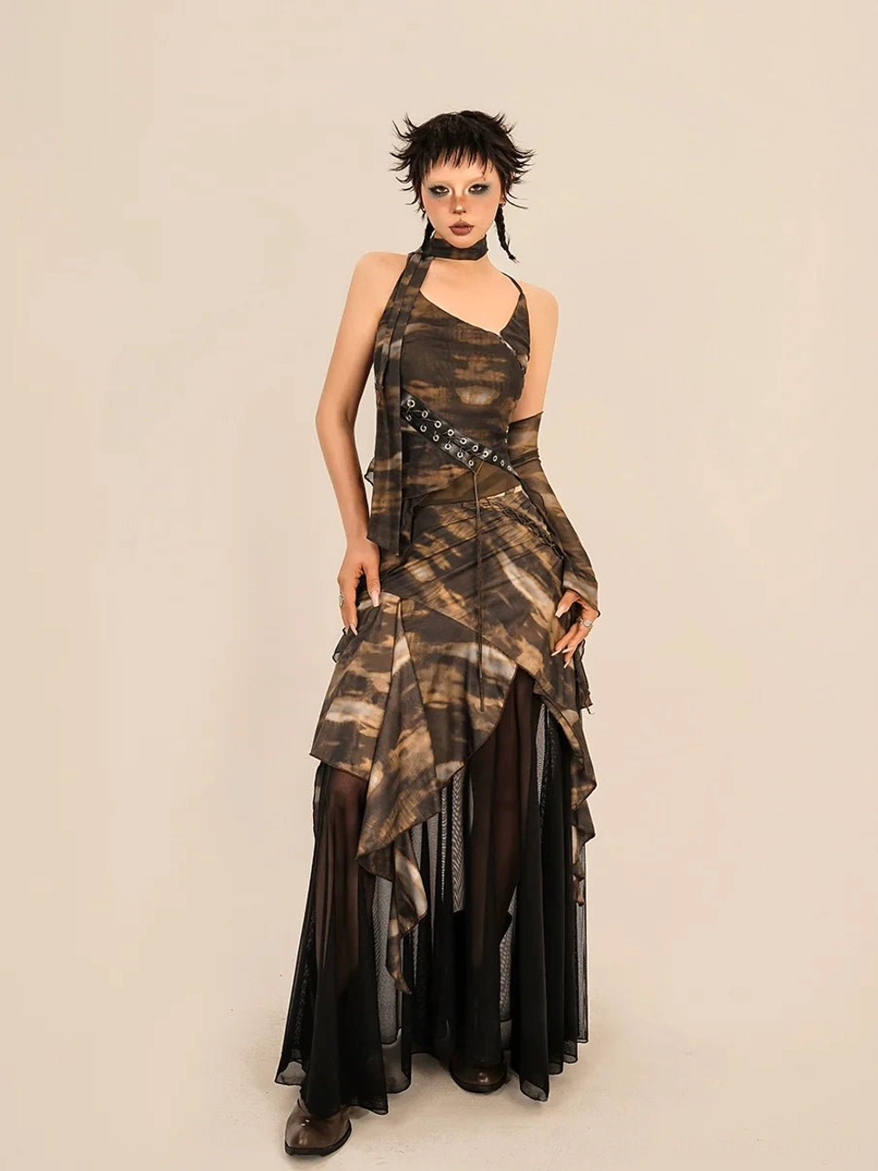 Front alternative view of brown and black abstract tie dye avant garde streetwear set with sculptural asymmetrical skirt matching choker and grommet belt