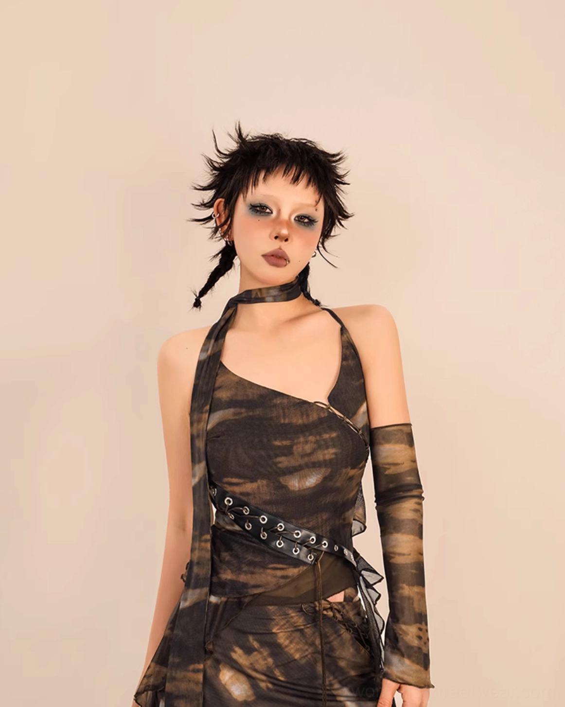 Close up of brown black tie dye asymmetrical V neck camisole top with decorative grommet waist belt sheer mesh sleeves and choker accessory
