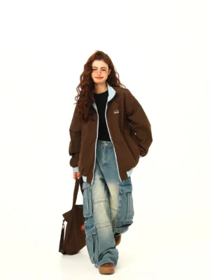 Dark brown oversized bomber jacket with light blue contrast collar styled with cargo jeans