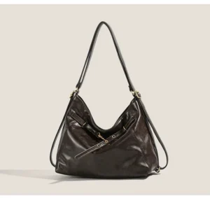 Brown vintage-inspired hobo shoulder bag shown from the front with adjustable straps, decorative buckle fastener details, and spacious everyday streetwear design