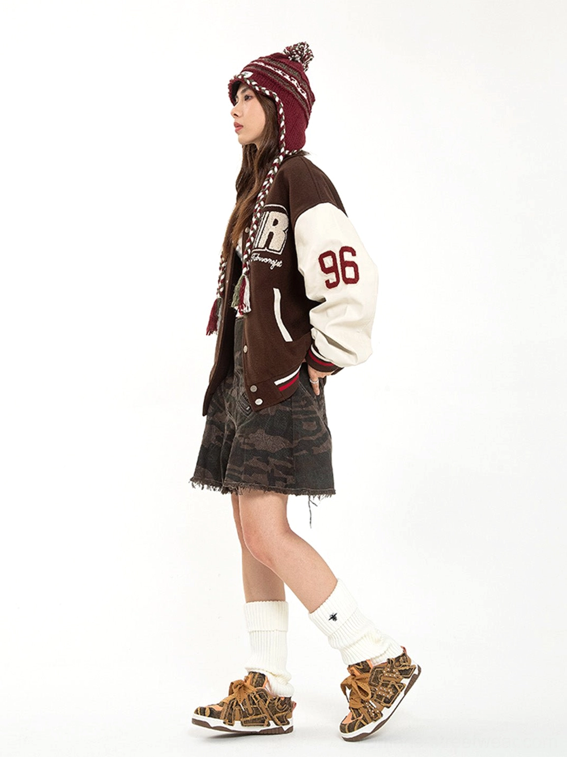 Side view of female streetwear outfit paired with brown camo rivet strap platform skate sneakers