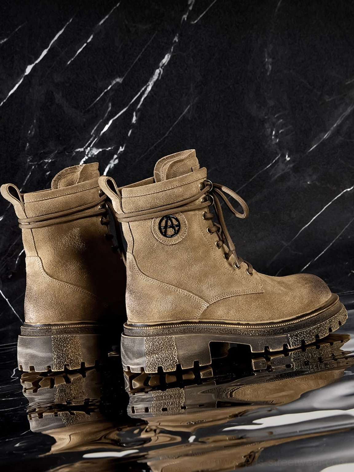 Brown distressed combat boots pair back view on black marble reflection background showing anti-slip lug outsole rear collar design