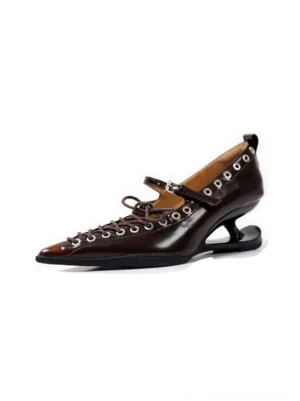 Single brown corset-lace pointed pump with glossy synthetic leather, metal eyelets, ankle buckle strap, and curved sculpted heel on a white studio background