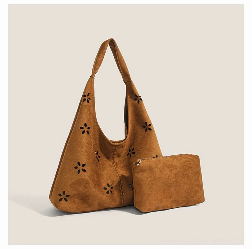 Brown daisy cutout suede-effect hobo tote bag displayed with matching mini zipper pouch