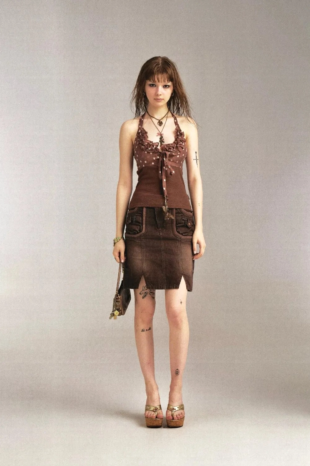 Full front studio view of brown denim pencil skirt featuring dual front flap pockets and front slit