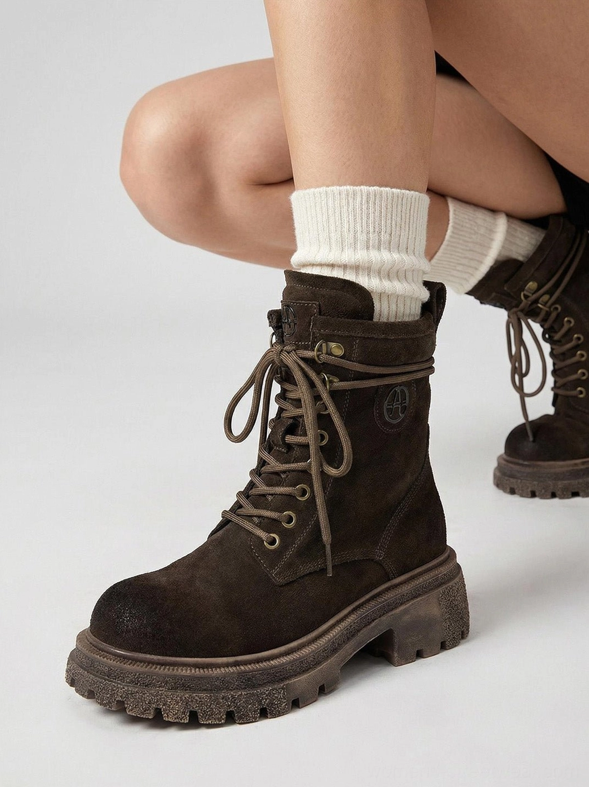 Brown distressed combat boots textured background showing aged patina appearance authentic weathering story