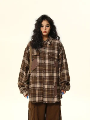 Brown oversized distressed patchwork plaid flannel shirt full front view showing button closure chest pockets and long-line fit