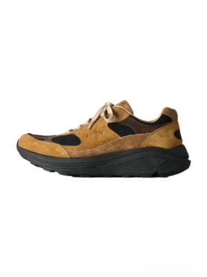 Brown distressed suede trail runner sneakers side profile with black breathable mesh and chunky lugged rubber sole