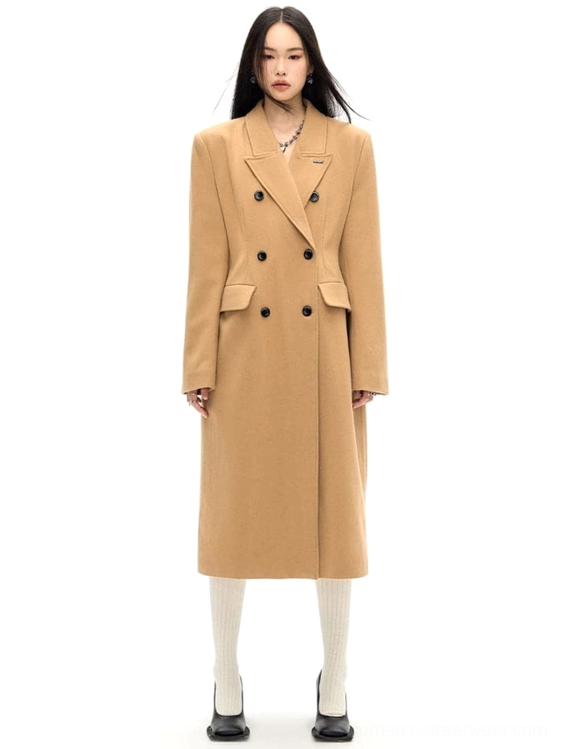 Brown double-breasted wool long coat with slim waist tailoring shown in a full front studio view