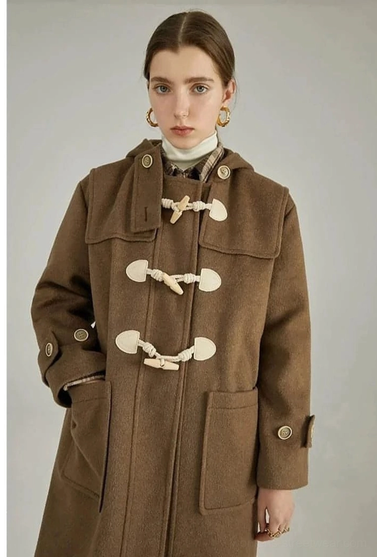Dark brown wool duffle coat three-quarter front view model hand in side pocket toggle buttons visible