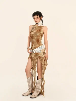 Three-quarter front view of brown dystopian streetwear sleeveless dress with fitted mock-neck bodice, raw asymmetric hem, and western boot styling