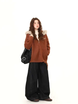Full front view of a women’s brown faux fur trim teddy zip hoodie jacket styled with wide-leg black pants and a shoulder bag