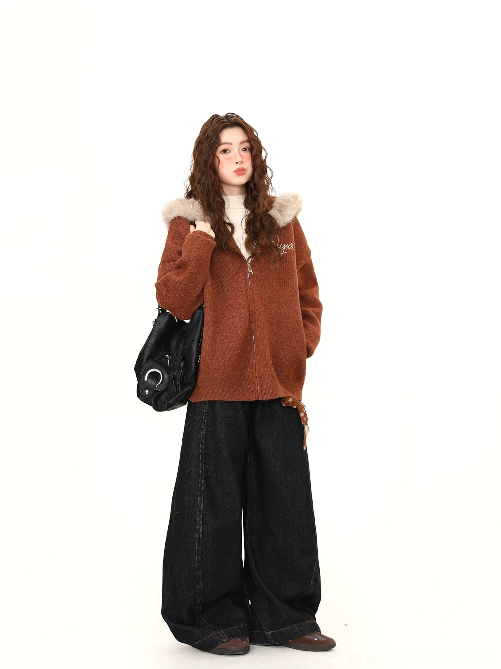 Full front view of a women’s brown faux fur trim teddy zip hoodie jacket styled with wide-leg black pants and a shoulder bag