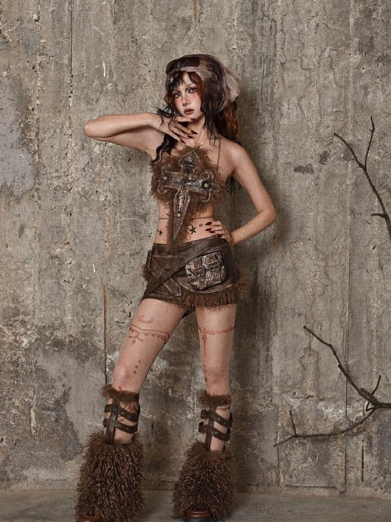 Brown faux leather tube top styled with furry cross ornament for alternative festival and avant-garde streetwear fashion