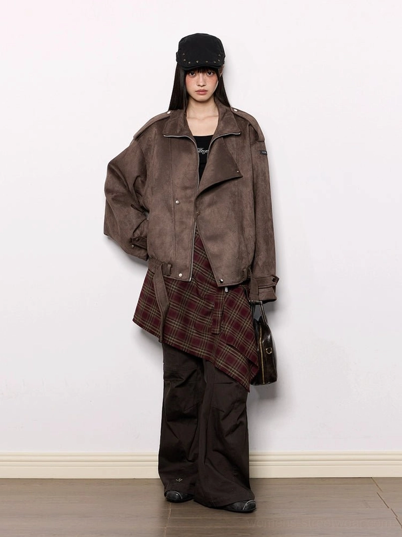 Oversized brown faux suede moto jacket styled with a black newsboy cap plaid wrap skirt wide-leg cargo pants and crossbody bag