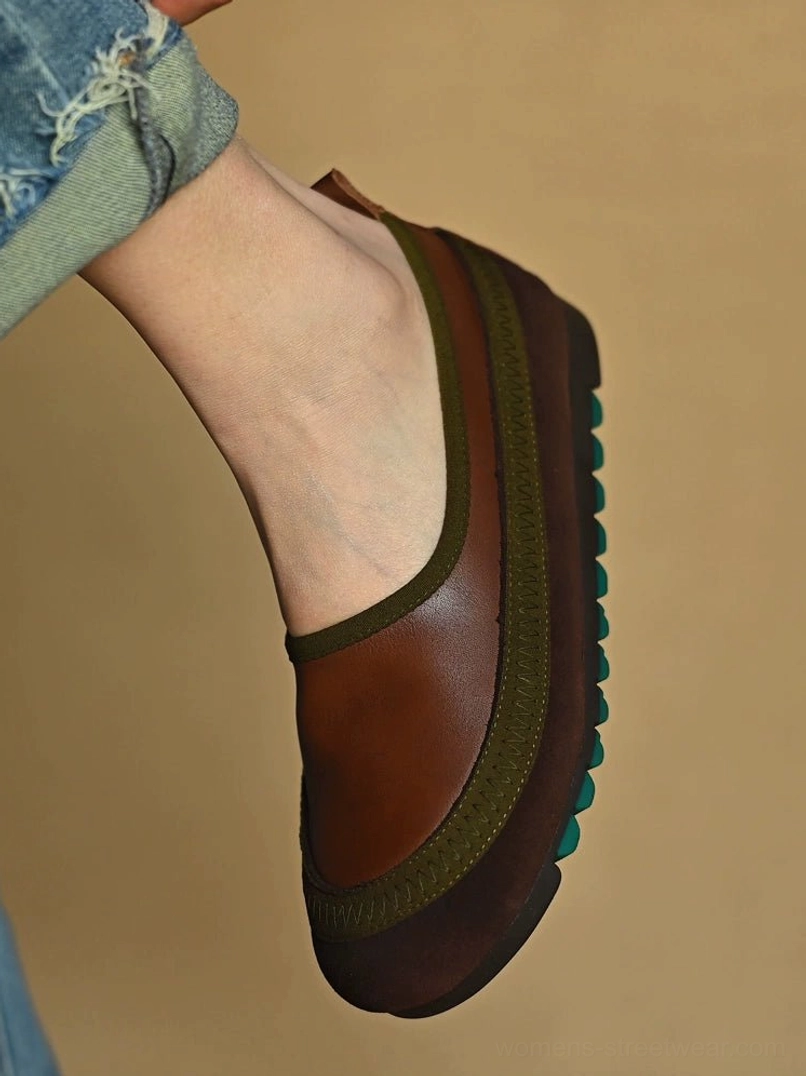 Side view of brown green leather slip-on shoes styled with blue frayed denim jeans and a rugged green studded outsole