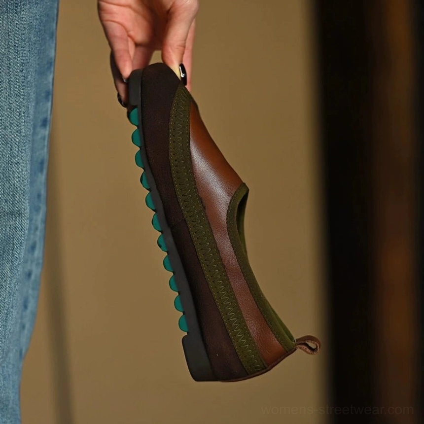 Rear view of a brown olive green slip-on leather shoe showing the pull tab, dark heel counter, and green anti-slip outsole studs