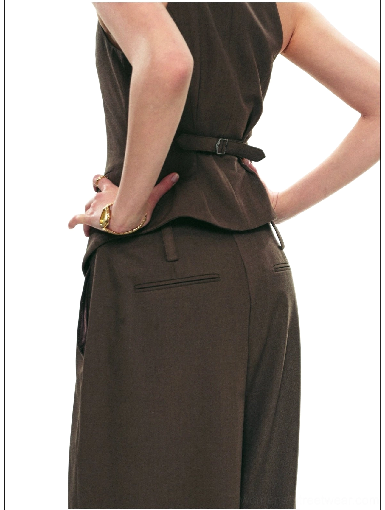 Back view of brown halter vest and high-waisted wide-leg trousers showing adjustable waist belt, back slit, and pockets