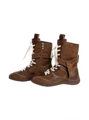 Pair of brown leather and suede mid-calf lace-up streetwear boots shown from front angle with side zippers and decorative straps