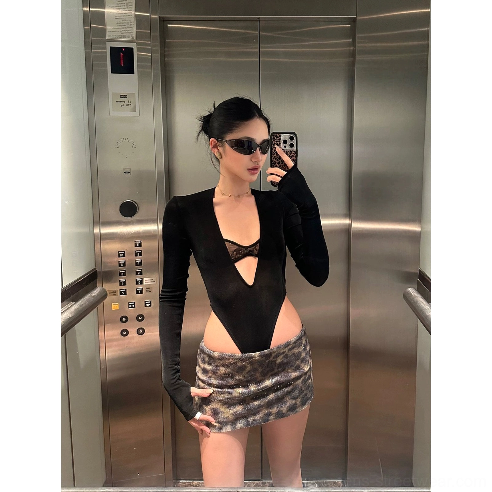 Brown leopard sequin mini skirt styled with a black cutout long sleeve bodysuit in an elevator mirror selfie